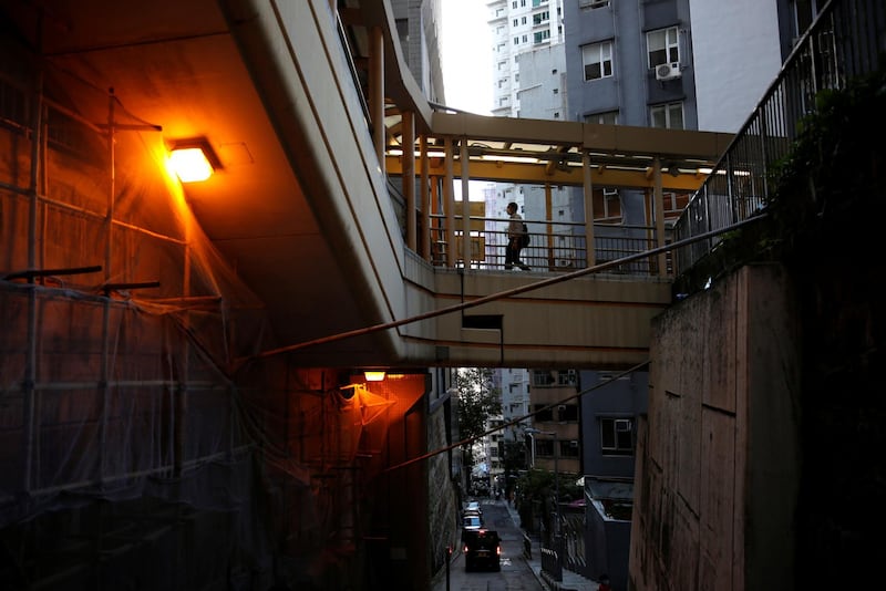 A man wearing a protective face mask walks at Mid-Levels Central, following the Covid-19 outbreak in Hong Kong, China. Reuters