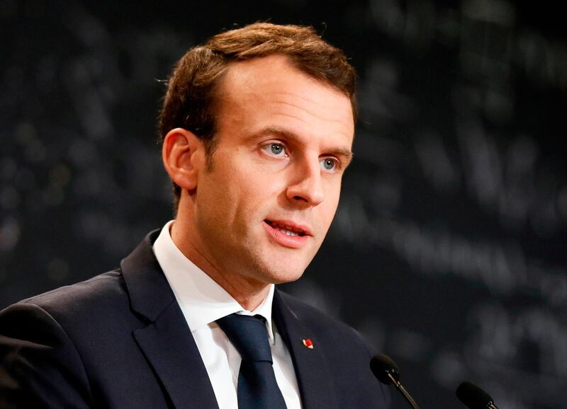 In this photo taken Thursday, March 29, 2018, French President Emmanuel Macron delivers a speech during the Artificial Intelligence for Humanity event in Paris. Macron met Thursday with Syrian opposition forces in Paris. Afterward, a Kurdish leader at the meeting claimed that Macron had promised to send troops to Manbij near Syria's border with Turkey. (Etienne Laurent/Pool Photo via AP)