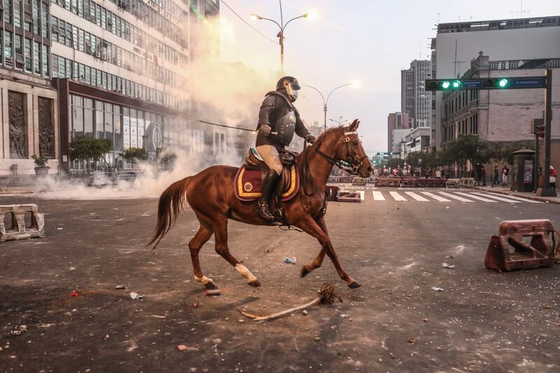 Mounted police confront anti-government protestors in Lima, Peru, April 5, 2022. EPA