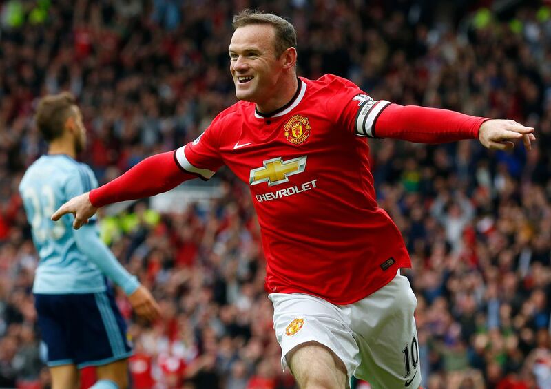 Manchester United striker Wayne Rooney celebrates scoring the opening goal during the Premier League match against West Ham United at Old Trafford on September 27, 2014. AFP
