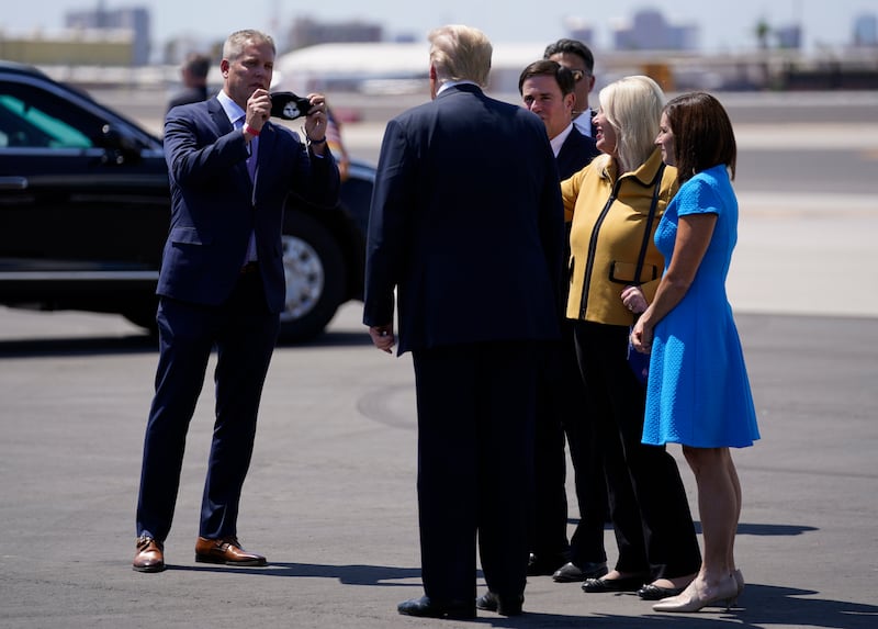 Donald Trump meets Clint Hickman, vice chairman of Arizona's 4th District, Maricopa County Board of Supervisors, at Phoenix Sky Harbour International Airport in Phoenix, Arizona, Mr Hickman said that he refused to take calls from the White House and Mr Trump, who he said was trying to overturn the battleground state's results. AP