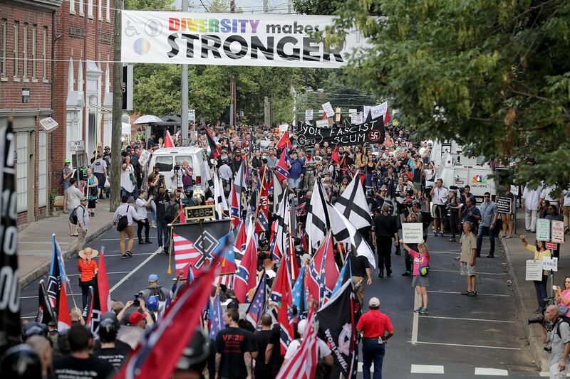 CHARLOTTESVILLE, VA - AUGUST 12: Hundreds of white nationalists, neo-Nazis and members of the "alt-right" march down East Market Street toward Emancipation Park during the "Unite the Right" rally August 12, 2017 in Charlottesville, Virginia. After clashes with anti-fascist protesters and police the rally was declared an unlawful gathering and people were forced out of Emancipation Park, where a statue of Confederate General Robert E. Lee is slated to be removed.   Chip Somodevilla/Getty Images/AFP