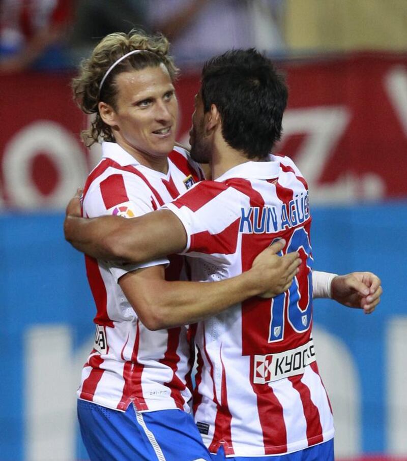 Diego Forlan, left, celebrates a goal with Atletico Madrid teammate Sergio Aguero. Andrea Comas / Reuters