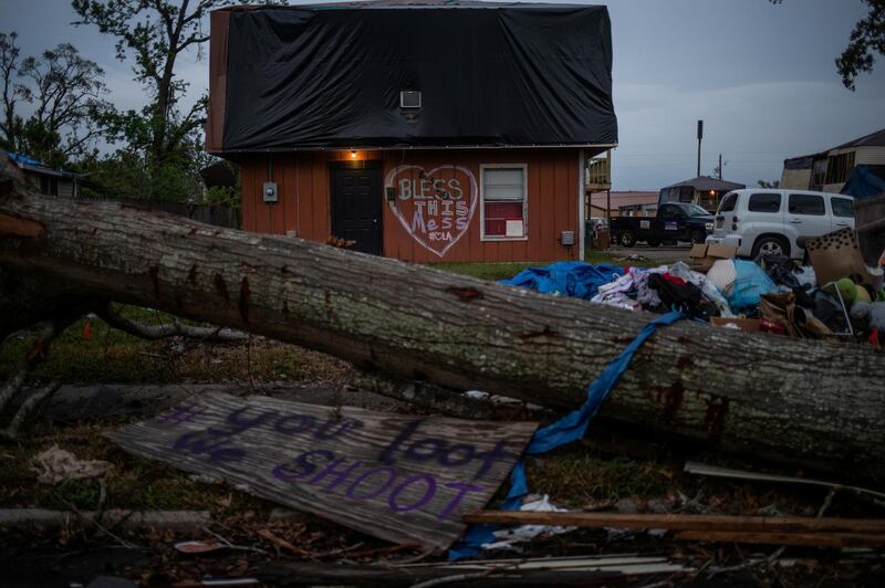 Signs and debris are seen outside a home left damaged by Hurricane Laura, ahead of the arrival of Hurricane Delta in Lake Charles, Louisiana, on October 8, 2020. Reuters