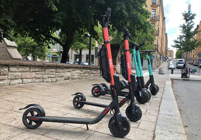 Electric scooters from Swedish startup VOI and Belin-based Tier sit parked side-by-side in Stockholm, Sweden July 7, 2019. Picture taken July 7, 2019. REUTERS/Esha Vaish