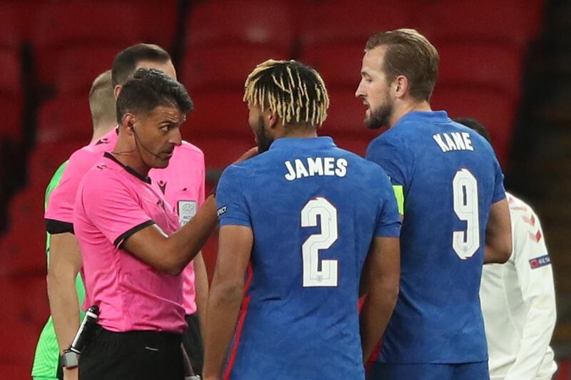 England defender Reece James (C) and striker Harry Kane talk with the referee Jesus Gil Manzano at the end of the game. AFP