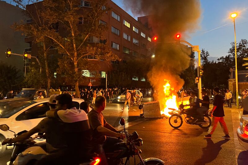 Demonstrators gathering around a burning barricade during a protest in Tehran. Nationwide unrest was sparked by the death of 22-year-old Mahsa Amini in police custody last month. AFP