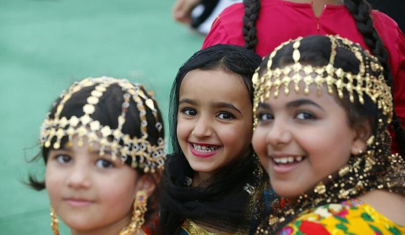 Emirati girls in traditional outfit, usually worn in their village by elderly women. Karim Sahib / AFP