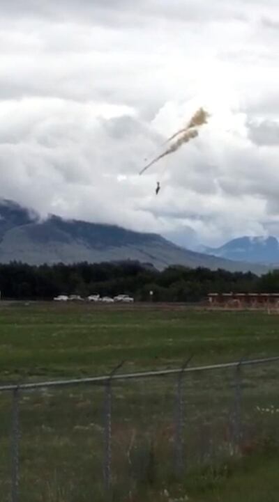 A plane of the Canadian Air Force's Snowbirds aerobatic demonstration team is seen prior crashing in Kamloops, British Columbia, Canada May 17, 2020, in this still image obtained from a social media video. Shannon Forrest/via REUTERS THIS IMAGE HAS BEEN SUPPLIED BY A THIRD PARTY. MANDATORY CREDIT. NO RESALES. NO ARCHIVES.