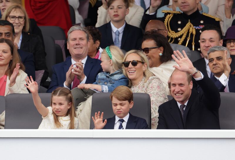 Princess Charlotte, Prince George and their father Prince William enjoy the pageant. PA