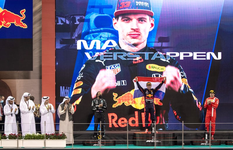 Race winner and 2021 F1 world champion Max Verstappen and his Red Bull Racing team celebrate on the podium after the Abu Dhabi Grand Prix at Yas Marina Circuit on December 12, 2021. Victor Besa / The National