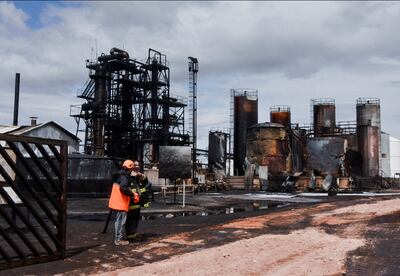 A firefighter stands outside the New American Oil refinery after an explosion killed several workers. Reuters