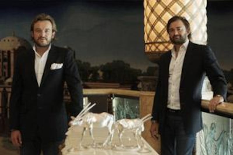 Alexander and (right) Forbes Mavros with their oryx sculptures at Emirates Palace.