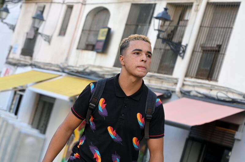 21-year-old Moroccan migrant Najib walks in the streets of Barcelona, on August 13, 2019. Spain is struggling to accommodate thousands of young migrants who over the years have arrived alone on rickety boats or hidden in trucks, pushing some onto the streets or even into crime. There are currently around 14,000 unacompanied young migrants in Spain, according to the government, up from just 4,000 in 2016. In some regions like Catalonia in Spain's northeast, which has a large Moroccan community that attracts the youngsters after they arrive in the south, reception centres are overwhelmed. / AFP / LLUIS GENE
