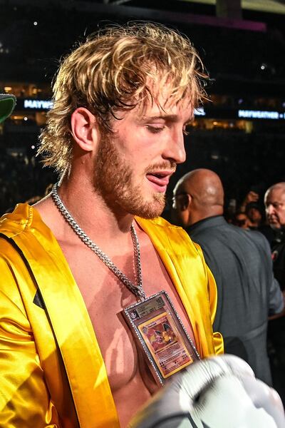 YouTube personality Logan Paul wears a pendant featuring a rare Charizard Pokemon card as he arrives to fight former world welterweight king Floyd Mayweather in an eight-round exhibition bout at Hard Rock Stadium in Miami, Florida on June 6, 2021. Floyd Mayweather predictably dominated YouTube star Logan Paul on Sunday night in an eight round exhibition fight at Hard Rock Stadium in Miami, Florida.
Mayweather, who weighed in at 155 lbs with his opponent tipping the scales at 189.5 lbs, produced a typically slick performance much to the delight of a substantial crowd at the home of the Miami Dolphins.
 / AFP / CHANDAN KHANNA
