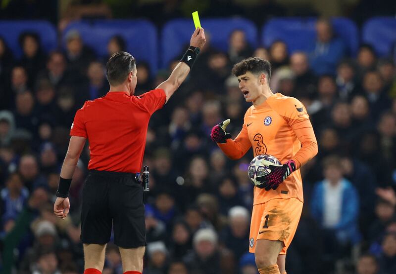 Chelsea's Kepa Arrizabalaga is shown a yellow card by referee Danny Makkelie. Reuters