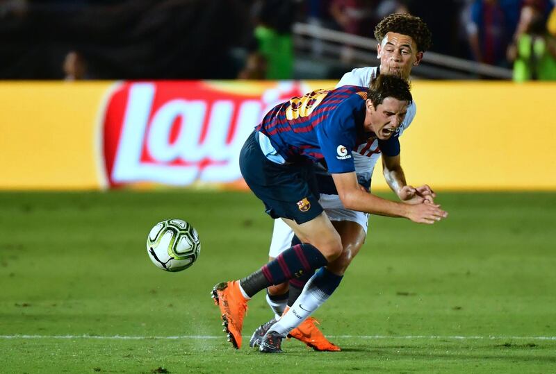 Juan Miranda of Barcelona fights for the ball with Luke Amos of Tottenham Hotspur. AFP