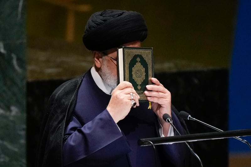 Iran’s President Ebrahim Raisi holds a Quran as he addresses the UN General Assembly in New York on September 19.  AP