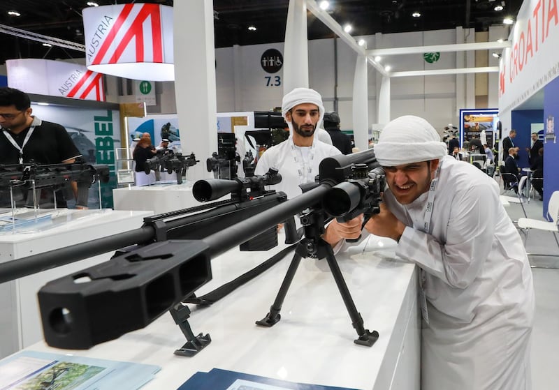 Abu Dhabi, U.A.E., February 18, 2019. INTERNATIONAL DEFENCE EXHIBITION AND CONFERENCE  2019 (IDEX) Day 2--  Visitors check out one of the 50mm sniper rifles at the exhibition.Victor Besa/The National