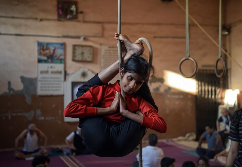 A young visually impaired Indian gymnast performs on a rope. AFP