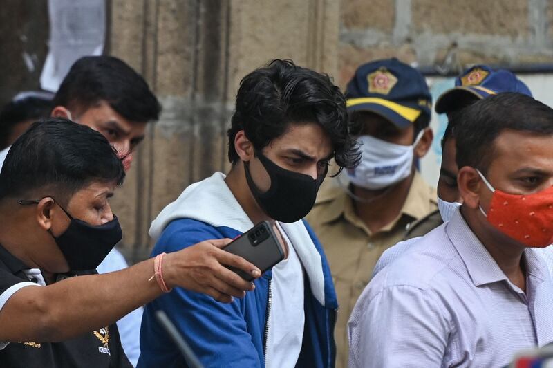 Aryan Khan, centre, the son of Bollywood actor Shah Rukh Khan, is escorted to court by Narcotics Control Bureau officials for a bail plea hearing in Mumbai on October 8, 2021. AFP