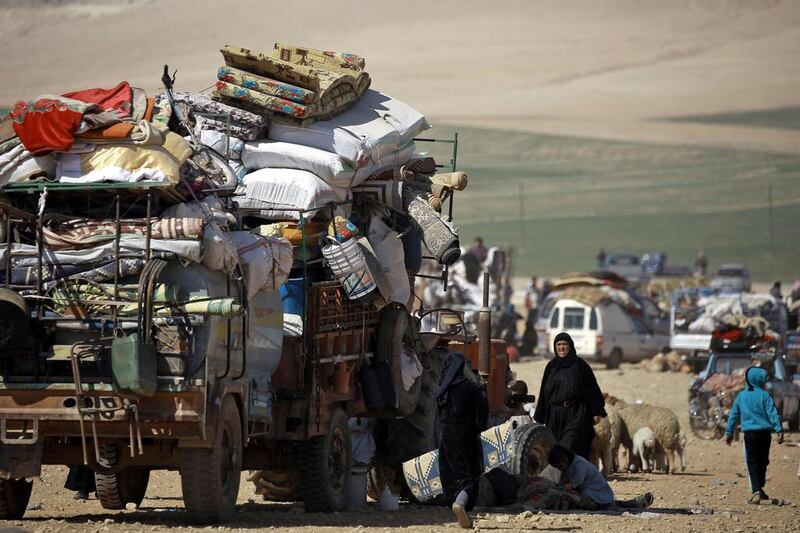 Displaced Syrians gather at a makeshift camp for those fleeing the northern Syrian town of Manbij on March 8, 2017, seeking safety in territory held by a Kurdish-Arab alliance called the Syrian Democratic Forces. Delil Souleiman/AFP