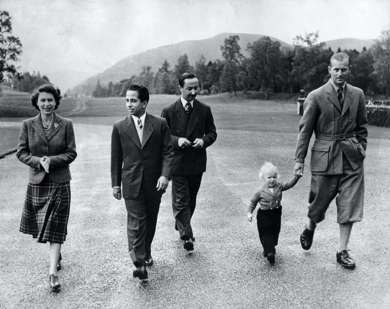 Queen Elizabeth II, wearing a tartan skirt and tweed jacket outside Balmoral Castle with her Royal visitors, King Faisal II and the Regent of Iraq, the Duke of Edinburgh, and Princess Anne.   (Photo by PA Images via Getty Images)