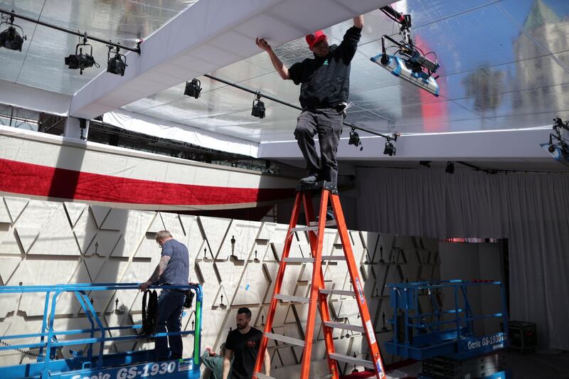 Workers construct a red carpet backdrop. Reuters