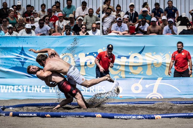 Mert Cikmaz (bottom) of Turkey competes against Nika Kenchadze of Georgia in the UWW Beach Wrestling World Series at Sarigerme, Turkey. All photos: Getty Images