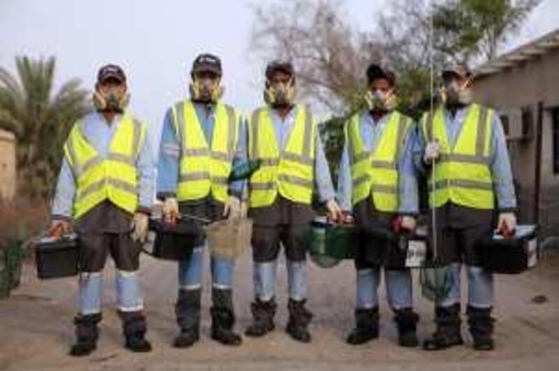 United Arab Emirates - Abu Dhabi - April 26 - 2010 : Workers from Eagle, enviromental services & pest control, pose for apicture after looking for malaria mosquitos in the irrigation water of a farm in Al Bahia town. ( Jaime Puebla / The National )