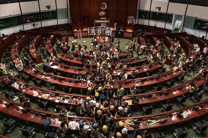 Protesters leave the parliament chamber of the government headquarters after announcement of the police clearing in Hong Kong, China. Getty Images