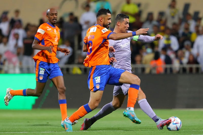 Cristiano Ronaldo runs with the ball against Al Feiha. AFP