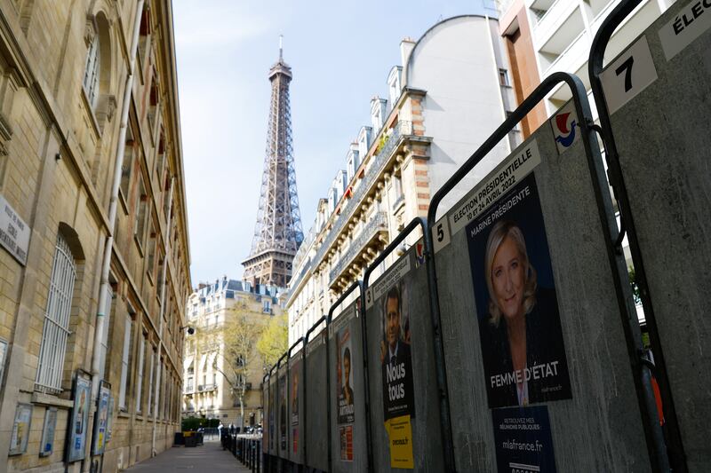 Official campaign posters of Marine le Pen and Emmanuel Macron pasted on bulletin boards near the Eiffel Tower in Paris. Reuters