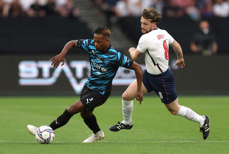 World XI's Patrice Evra in action with England's Tom Grennan. Reuters