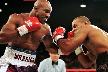 Evander Holyfield lands a punch on Mike Tyson in the first round of their second fight in June 1997. Reuters