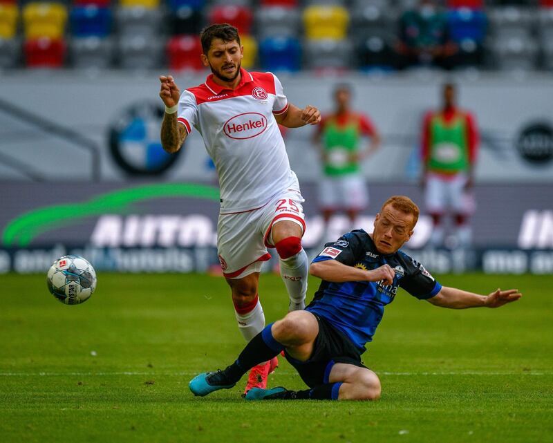 Fortuna Dusseldorf defender Matthias Zimmermann is tackled by Paderborn's Sebastian Vasiliadis. The match finished 0-0. AFP