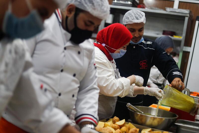 Nagwa Fathi, an Egyptian chef and founder of the 'We are with You' campaign, cooks with other chefs nutritious meals for medical staff at hospitals tackling the coronavirus disease, in Cairo, Egypt. Reuters