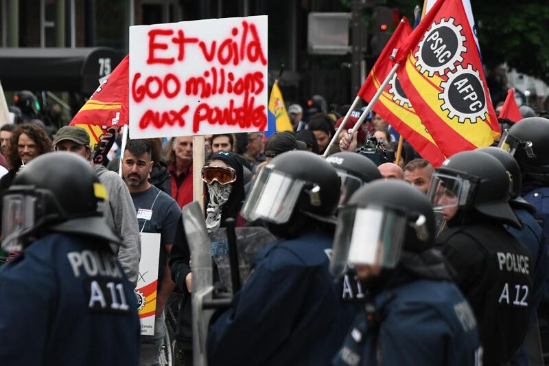 Riot police watch protesters pass by. Martin Ouellet-Diotte / AFP Photo