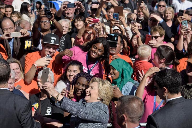 Democratic US presidential nominee Hillary Clinton takes a selfie during an Iowa Democratic party vote rally on September 29, 2016, in Des Moines, Iowa. Brendan Smialowski / Agence France-Presse
