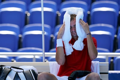 Daniil Medvedev cools down with an ice towel during his match against Alexander Bublik, of Kazakhstan at the Olympics.