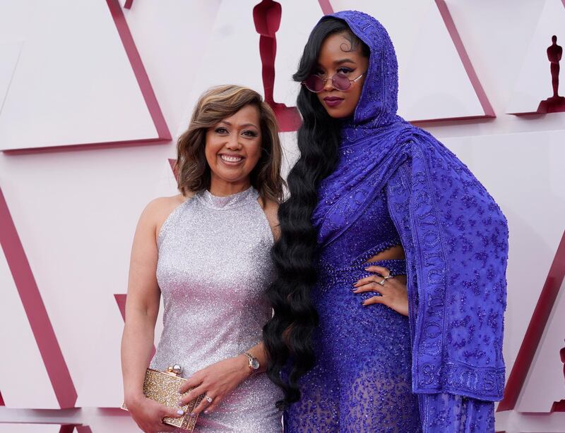 Agnes Wilson, left, and H.E.R. arrive to the Oscars red carpet for the 93rd Academy Awards in Los Angeles, California, US, April 25, 2021. AP Photo