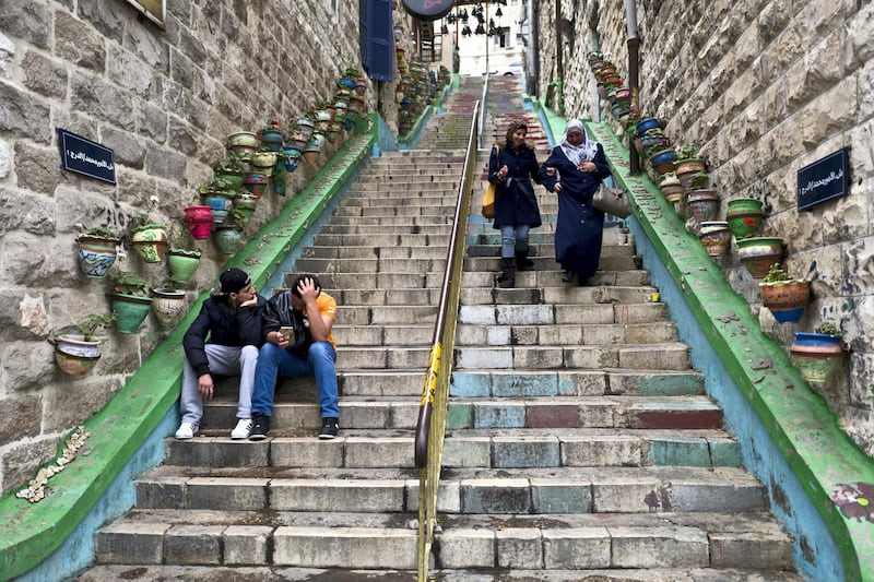 Jordanian youth rest on stairs in downtown Amman, Jordan, Saturday, March 26, 2016. (AP Photo/Muhammed Muheisen)
