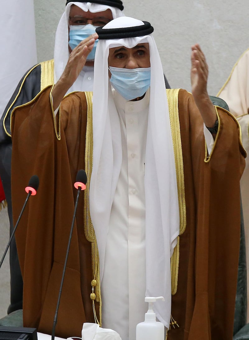 Sheikh Nawaf Al Sabah salutes the crowd after being sworn in as Kuwait's new Emir at the National Assembly in Kuwait City.  AFP