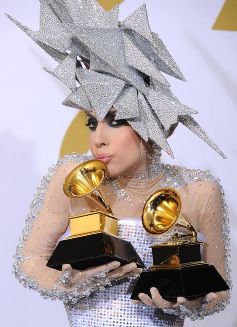Musician Lady Gaga poses backstage with her awards for Best Dance Recording and Best Electronic Dance Album at the Grammy Awards on Jan. 31, 2010, in Los Angeles. Matt Sayles / AP photo