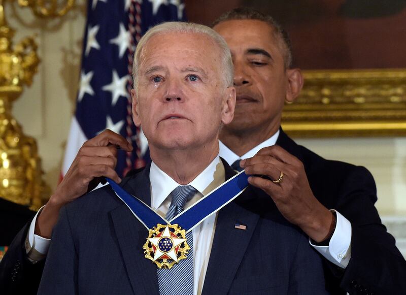 Mr Biden receives his Presidential Medal of Freedom in 2017. AP
