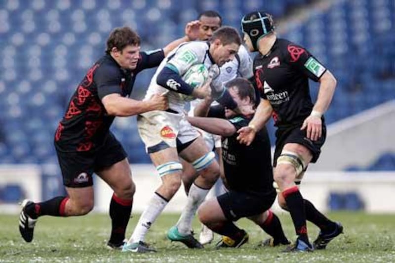 Yannick Caballero, centre, the Castres flanker, is tackled by the Edinburgh defence.