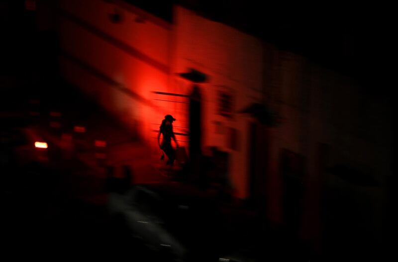 A person walks through the streets of a neighborhood without electricity during a power outage in Caracas, Venezuela. EPA