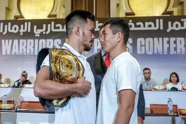 Featherweight champion Rolando Dy, left, goes head-to-head with challenger Lee Do-gyeom at Wednesday's press conference in Abu Dhabi. Victor Besa / The National​​​​​​