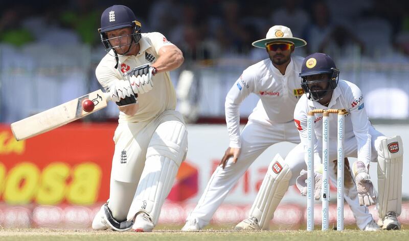 England's cricketer Jos Buttler (L) plays a shot as Sri Lanka's wicketkeeper Niroshan Dickwella (R) looks on during the third day of the third Test match between Sri Lanka and England at the Sinhalese Sports Club (SSC) international cricket stadium in Colombo on November 25, 2018. / AFP / ISHARA S.  KODIKARA
