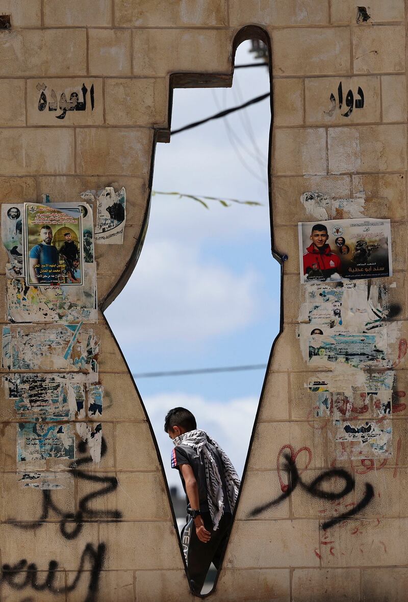 A Palestinian passes a monument depicting Mandatory Palestine in the West Bank town of Jenin. AFP